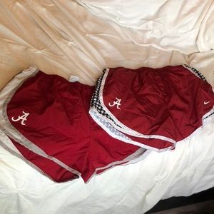 TWO pairs of nike running shorts with Alabama logo